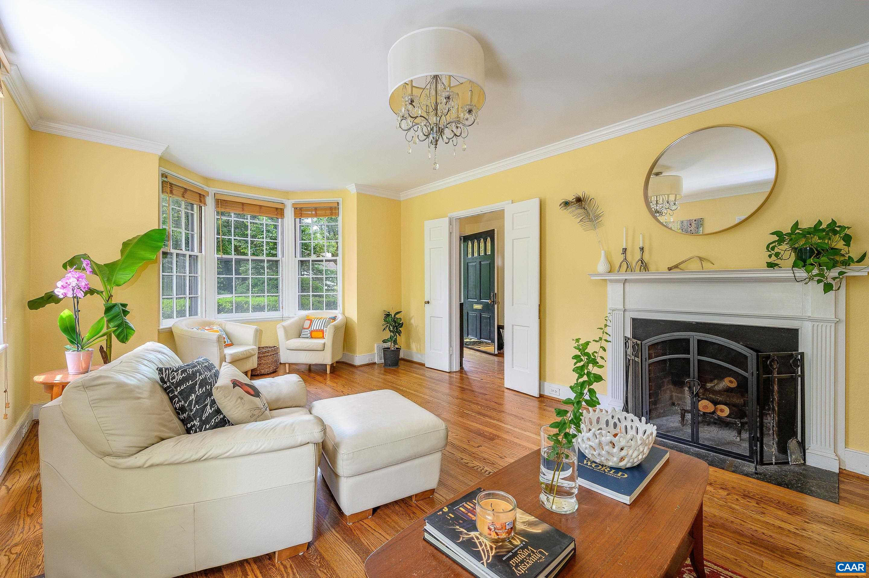 1939 Thomson Road Charlottesville, VA 22903 - Photo 4 of 35 a living room with furniture a chandelier and a fireplace