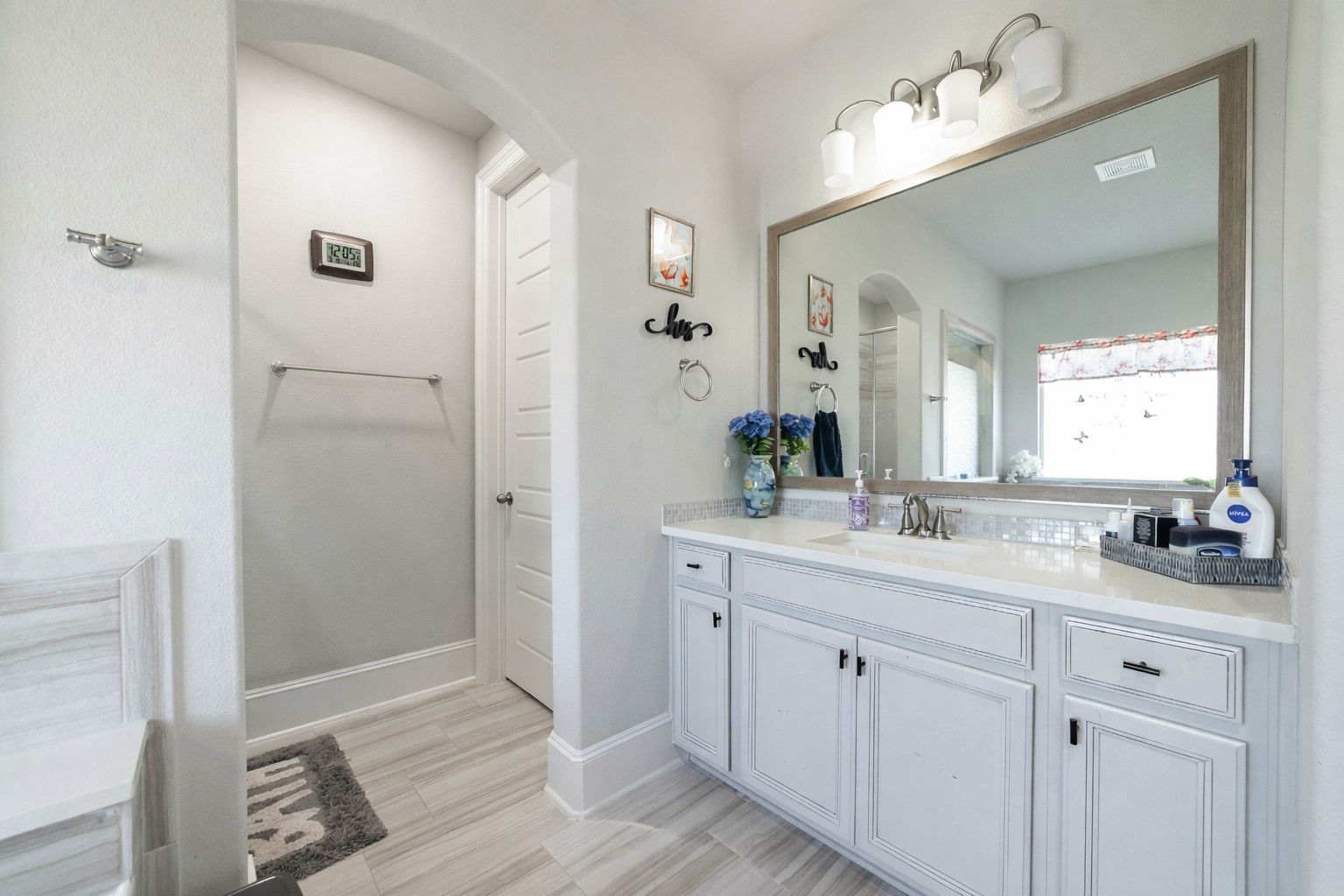 17821 Limestone Spring Lane Austin, TX 78738 - Photo 21 of 40 a bathroom with a double vanity sink and mirror