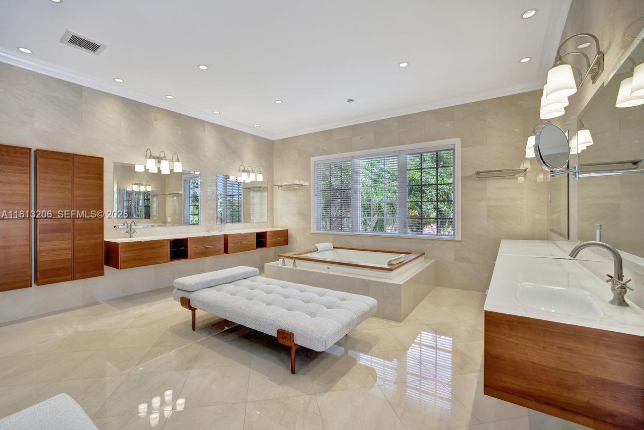 797 Ridgewood Road Key Biscayne, FL 33149 - Photo 11 of 23 a bathroom with a tub double vanity sink and glass door