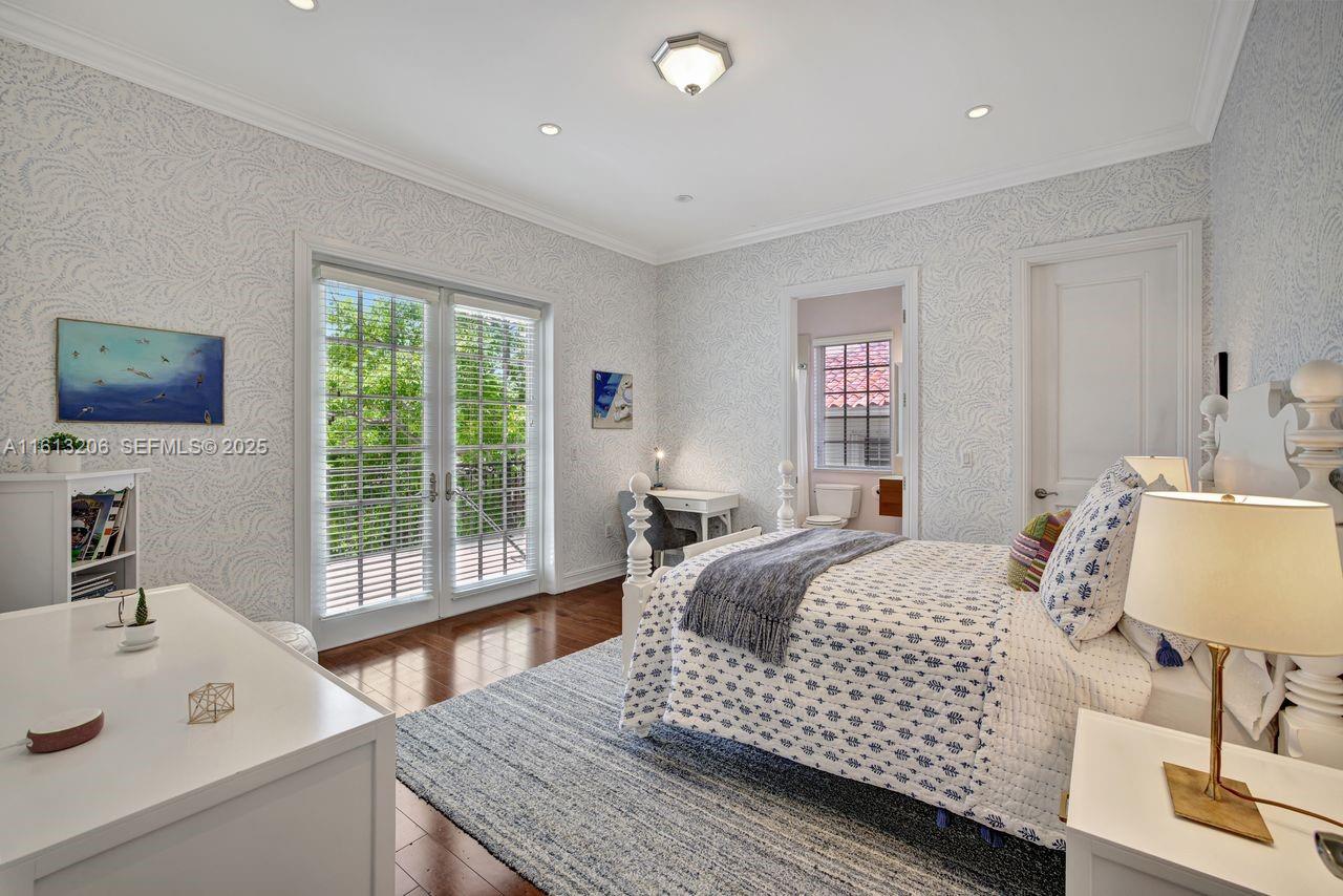 797 Ridgewood Road Key Biscayne, FL 33149 - Photo 15 of 23 a bedroom with a bed and a table