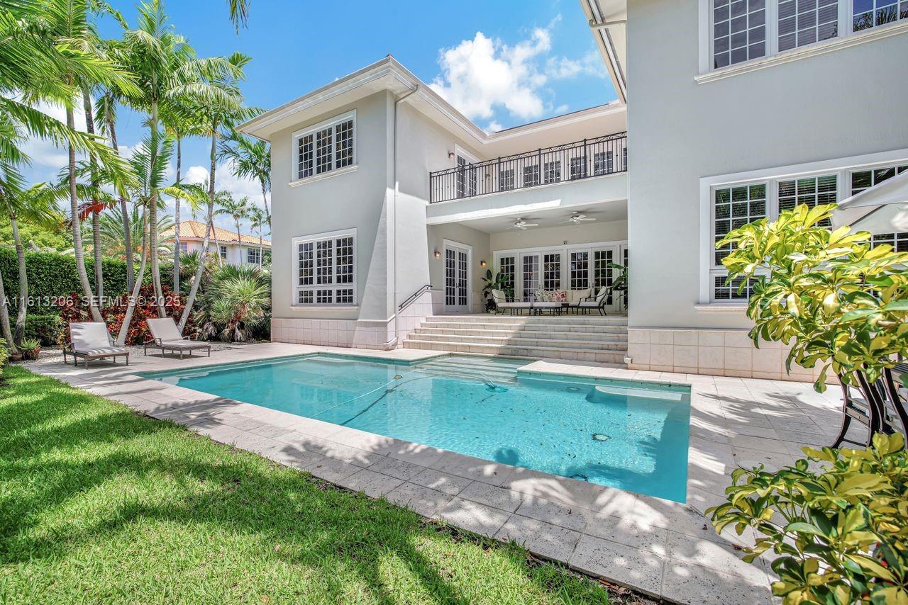 797 Ridgewood Road Key Biscayne, FL 33149 - Photo 17 of 23 a front view of a house with garden and sitting area