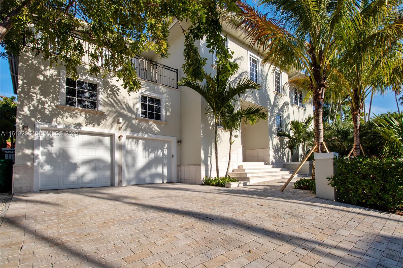 797 Ridgewood Road Key Biscayne, FL 33149 - Photo 2 of 23 a view of a house with a tree