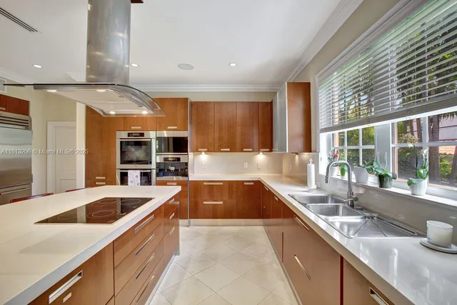 a large kitchen with stainless steel appliances granite countertop a sink and a stove