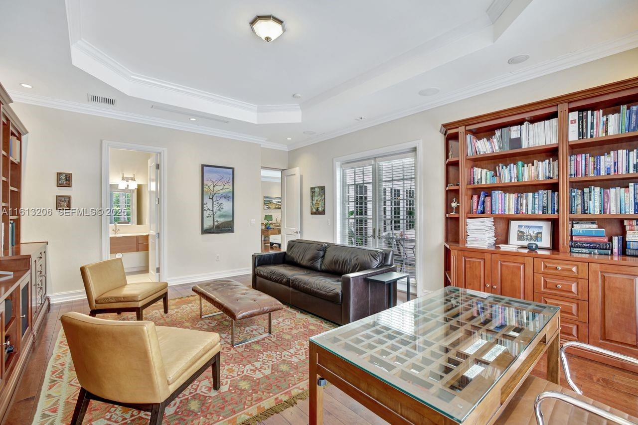 797 Ridgewood Road Key Biscayne, FL 33149 - Photo 8 of 23 a living room with furniture and a book shelf