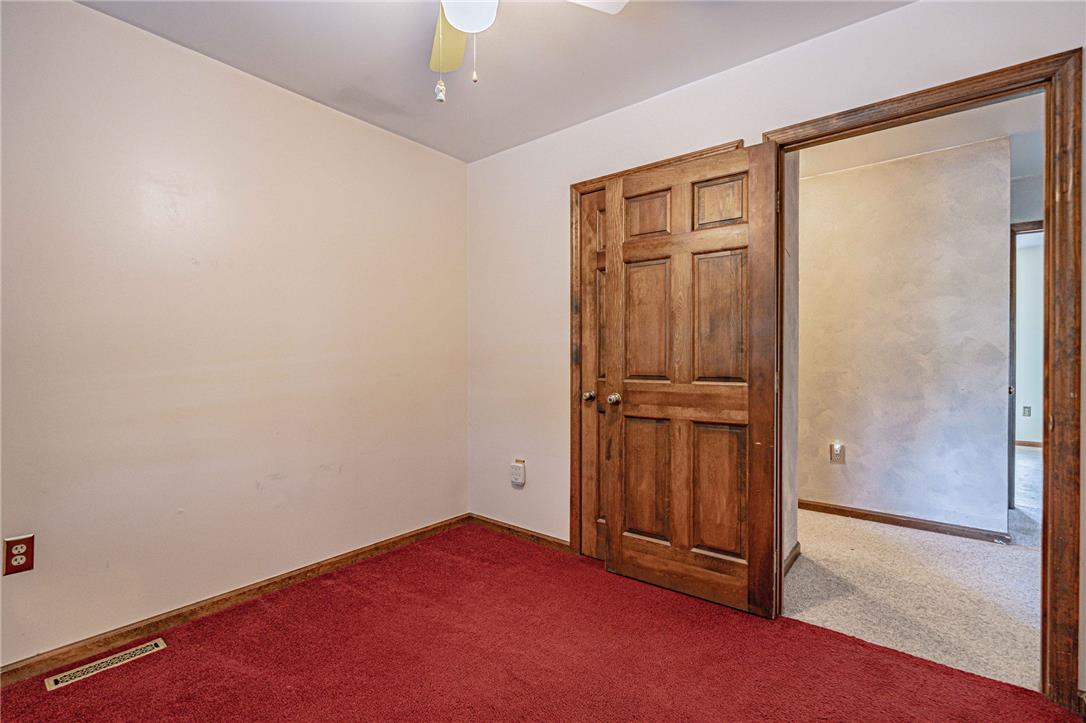 652 Old State Road Oley, PA 19547 - Photo 29 of 54 A cheerful room with vibrant carpeting and natural wood doors awaits personalization.