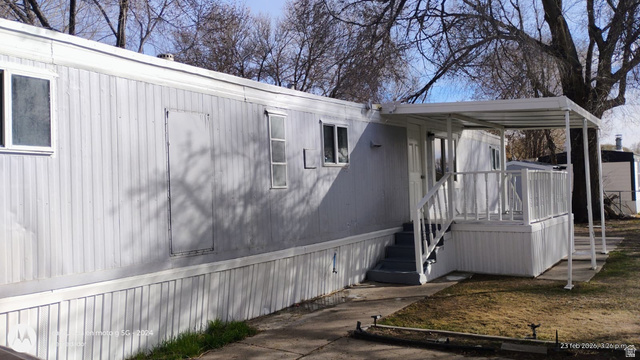 8155 South Redwood Road, Unit 96 West Jordan, UT 84088 - Photo 3 of 17 View of home's exterior featuring a deck