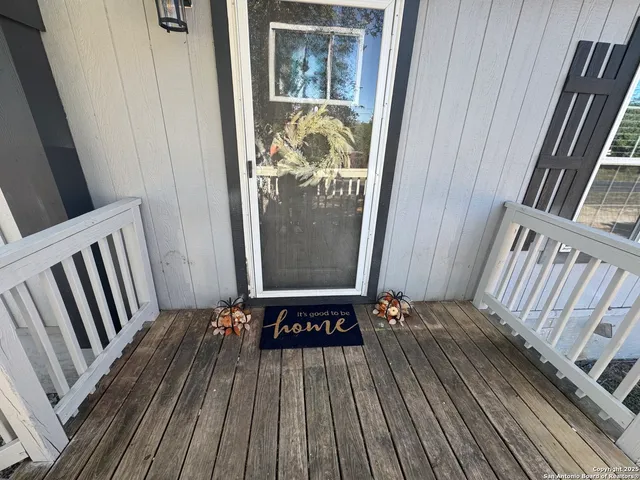 a view of wooden floor in a small bathroom
