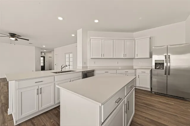 a kitchen with white cabinets and white appliances