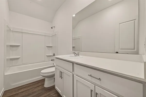 a bathroom with a sink toilet vanity and bathtub