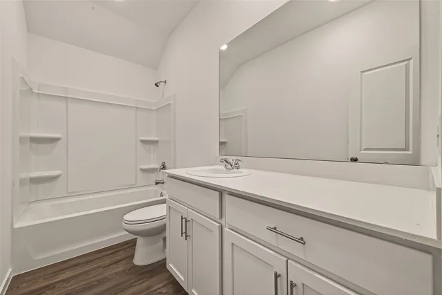 a bathroom with a sink toilet vanity and bathtub