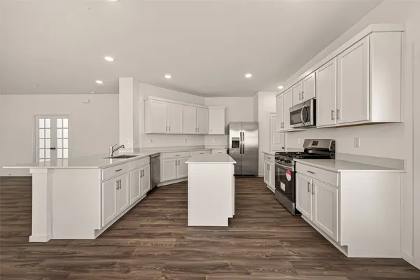 a kitchen with a white wooden cabinets and white appliances