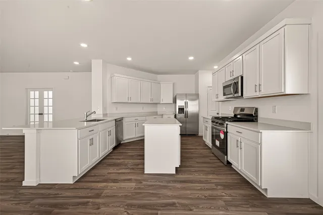 a kitchen with a white wooden cabinets and white appliances