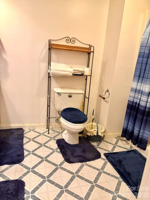 4084 Carpenters Cove Road Claremont, NC 28610 - Photo 9 of 27 a bathroom with a toilet and a mirror