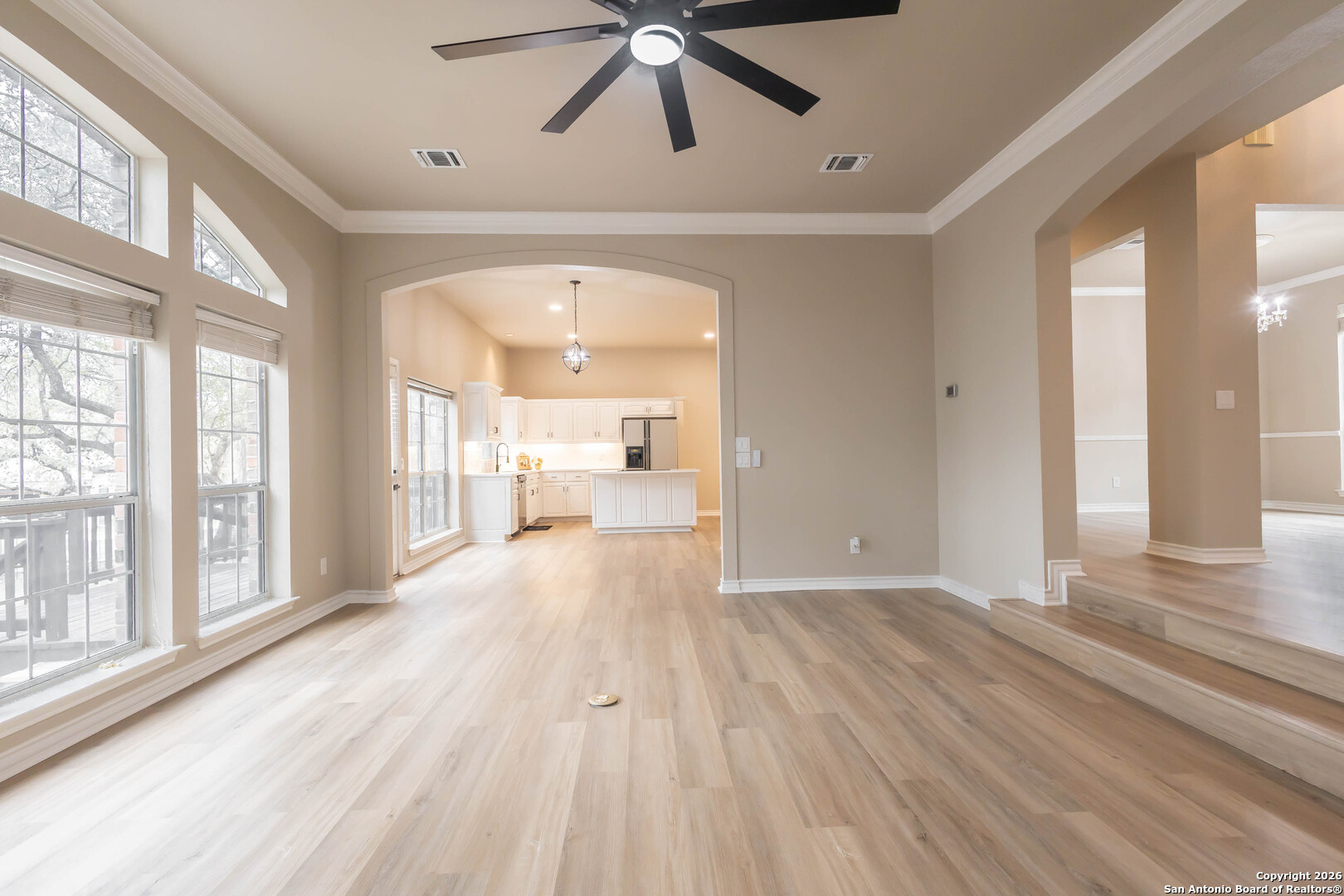 18202 Crystal Ridge Drive San Antonio, TX 78259 - Photo 11 of 53 a view of a hallway with wooden floor and a ceiling fan