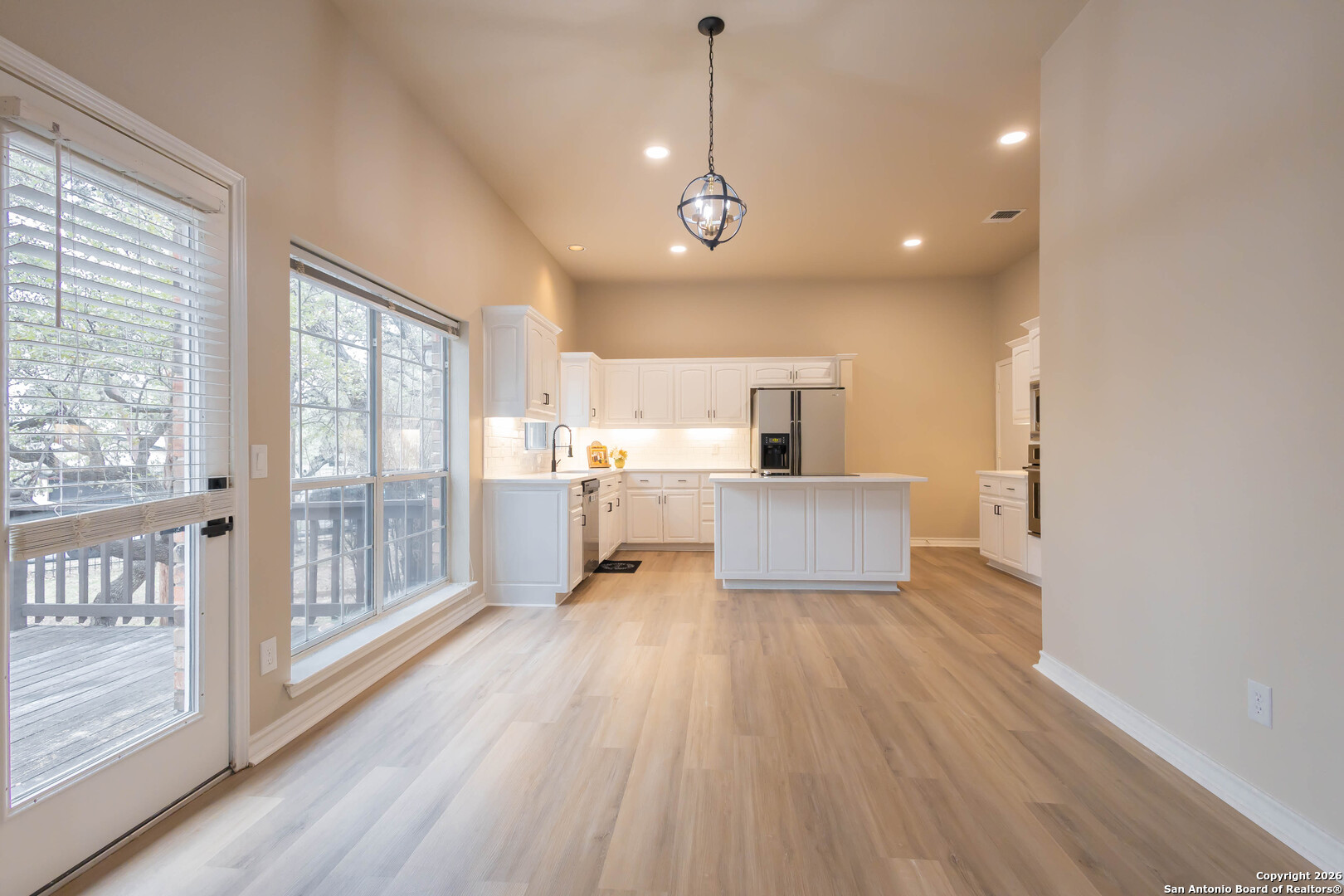 18202 Crystal Ridge Drive San Antonio, TX 78259 - Photo 14 of 53 a view of a kitchen with refrigerator and wooden floor