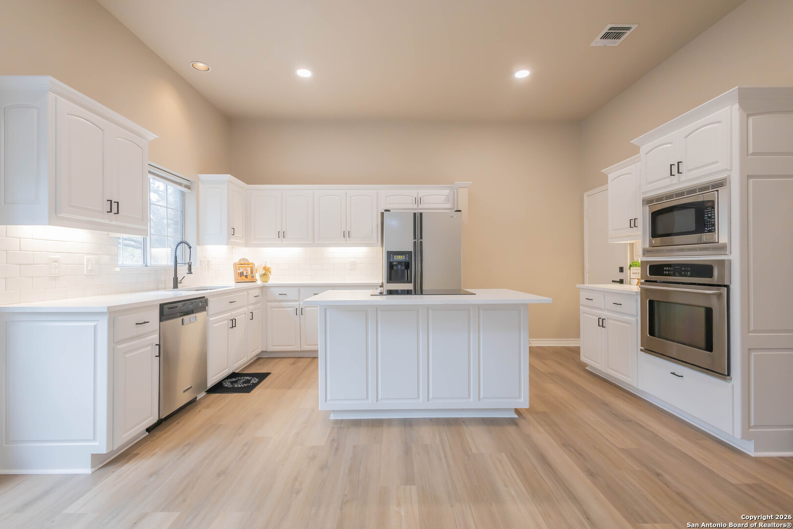 18202 Crystal Ridge Drive San Antonio, TX 78259 - Photo 16 of 53 a kitchen with white cabinets stainless steel appliances and sink