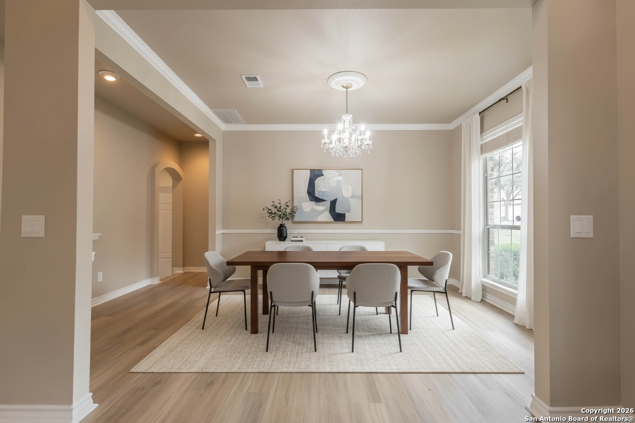 18202 Crystal Ridge Drive San Antonio, TX 78259 - Photo 24 of 53 a dining room with chandelier and wooden floor