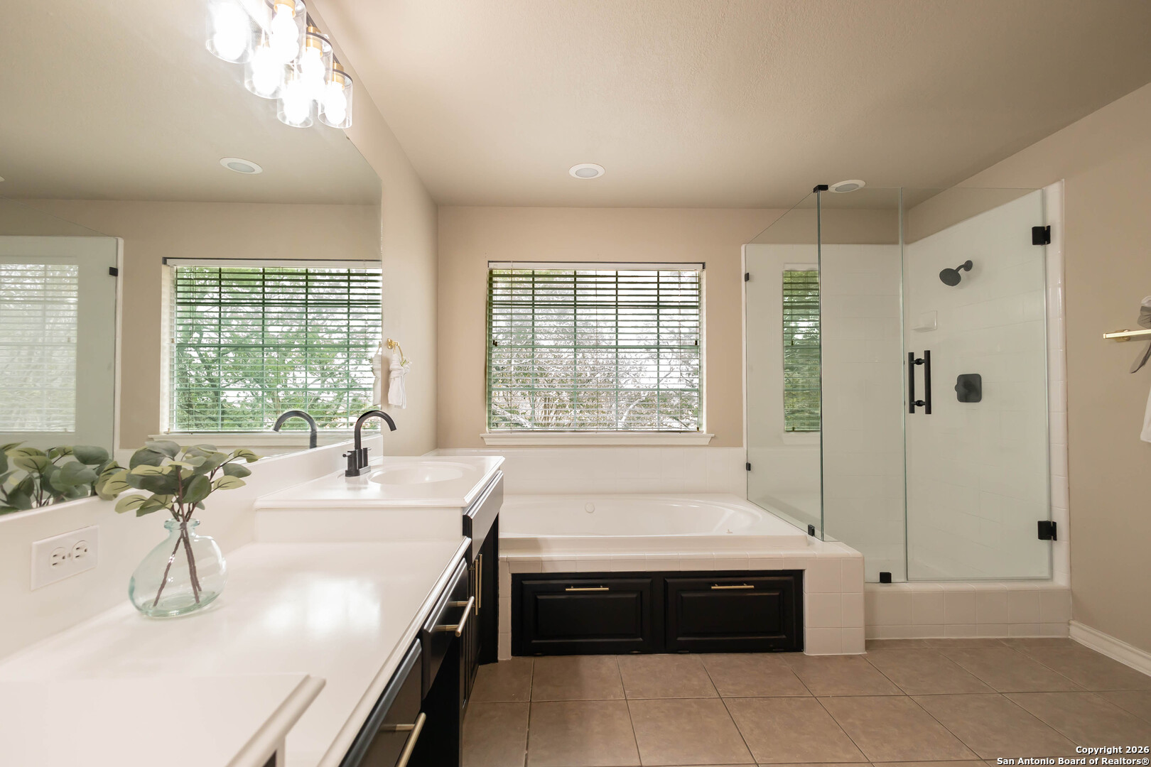 18202 Crystal Ridge Drive San Antonio, TX 78259 - Photo 34 of 53 a bathroom with a bathtub a sink and a large window