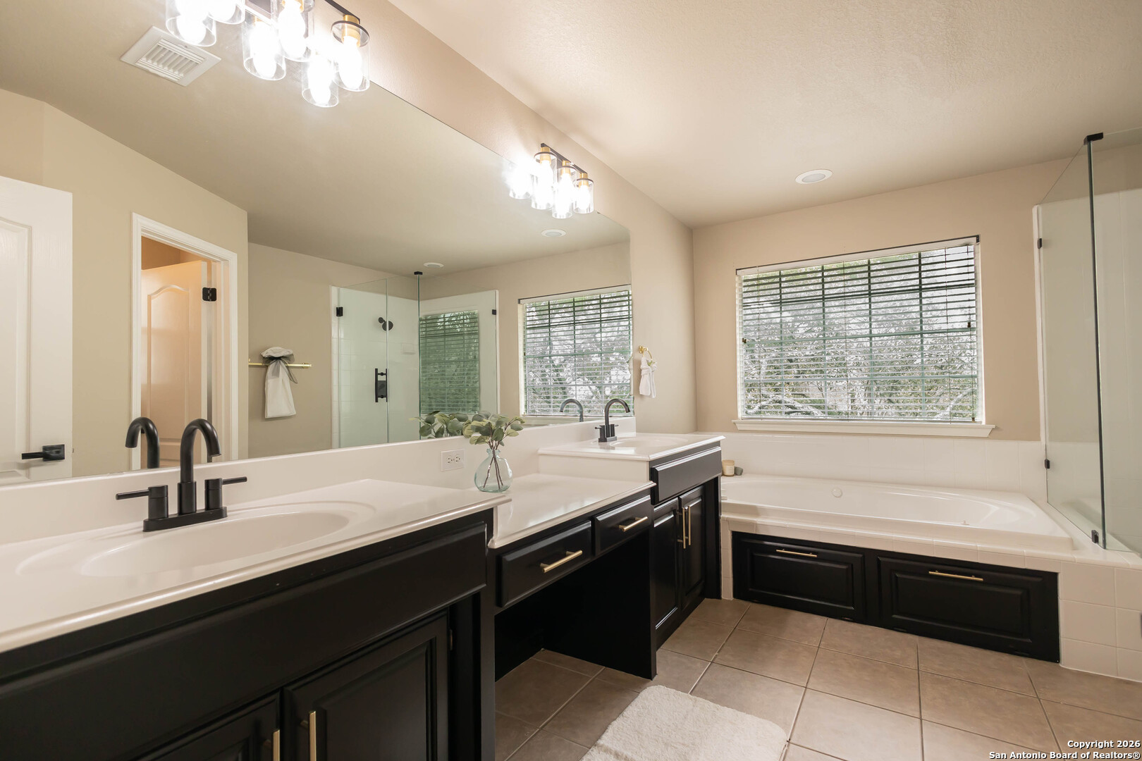18202 Crystal Ridge Drive San Antonio, TX 78259 - Photo 36 of 53 a bathroom with a bathtub sink and mirror