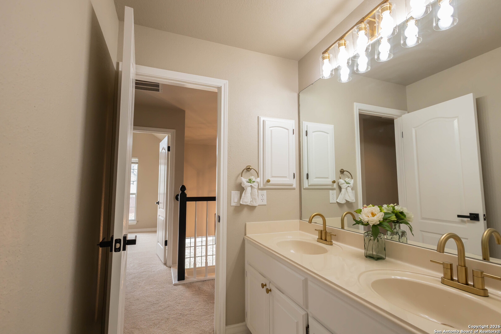 18202 Crystal Ridge Drive San Antonio, TX 78259 - Photo 42 of 53 a bathroom with double vanity sinks and a mirror