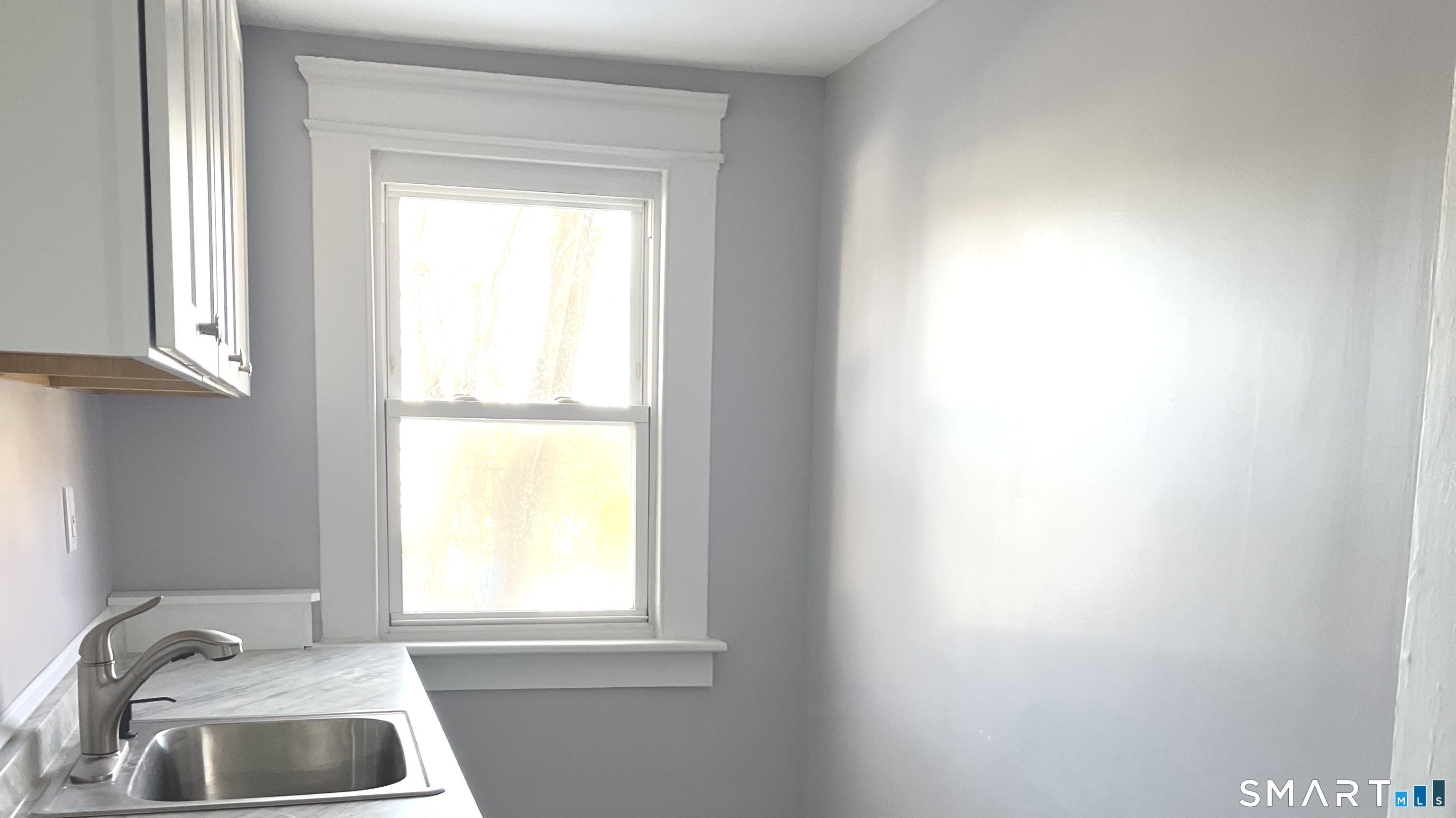 65 Chambers Street, Unit 1 Waterbury, CT 06708 - Photo 2 of 11 a bathroom with a window a sink and a window
