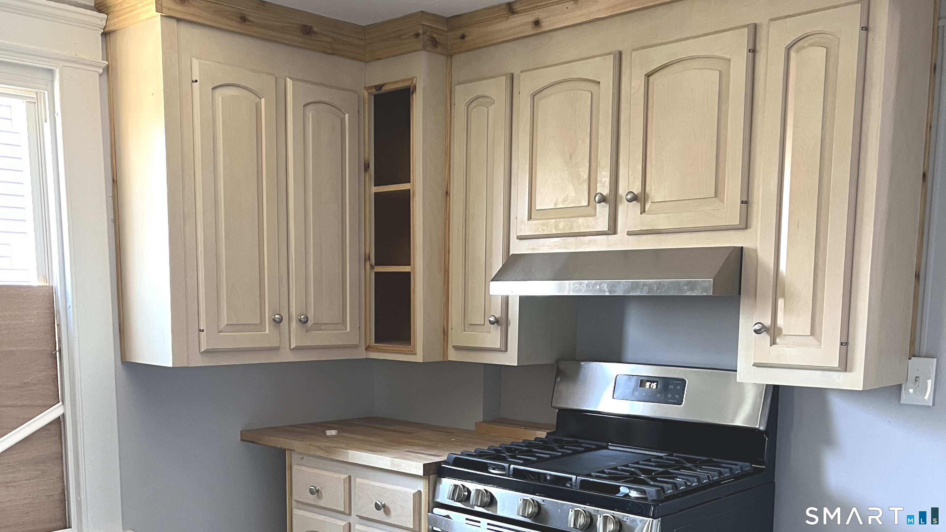 65 Chambers Street, Unit 1 Waterbury, CT 06708 - Photo 3 of 11 a kitchen with granite countertop white cabinets and black appliances