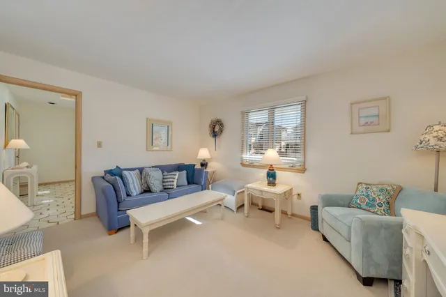 a bedroom with two beds and painting on the wall