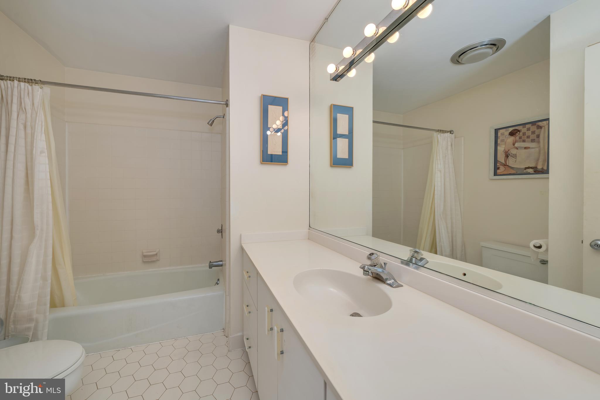 177 74th Street Avalon, NJ 08202 - Photo 32 of 54 a bathroom with a tub a sink and mirror