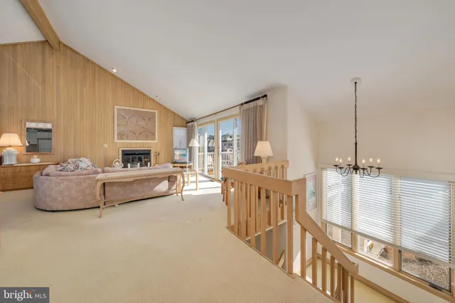 a living room with furniture large window and a fireplace