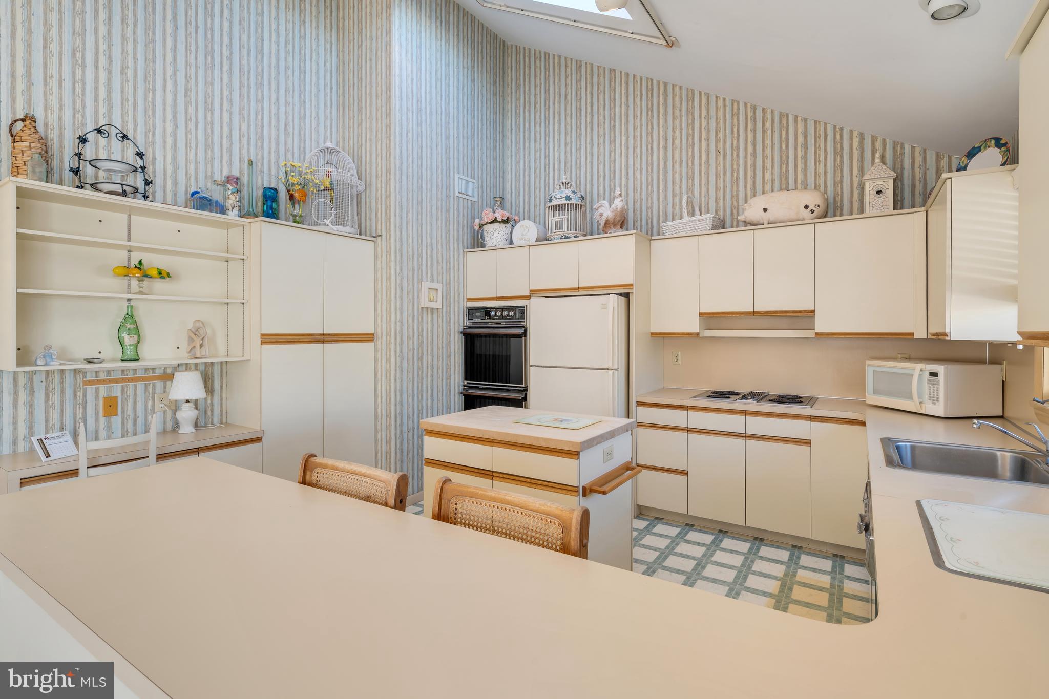 177 74th Street Avalon, NJ 08202 - Photo 46 of 54 a kitchen with cabinets and white appliances