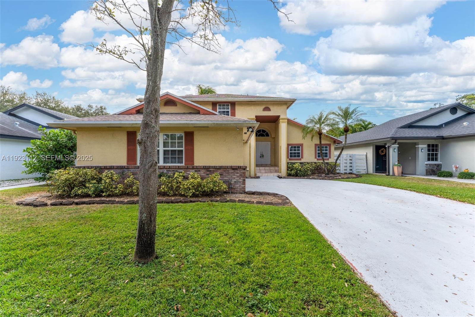 15016 Southwest 139th Avenue Miami, FL 33186 - Photo 1 of 24 a front view of house with yard and green space
