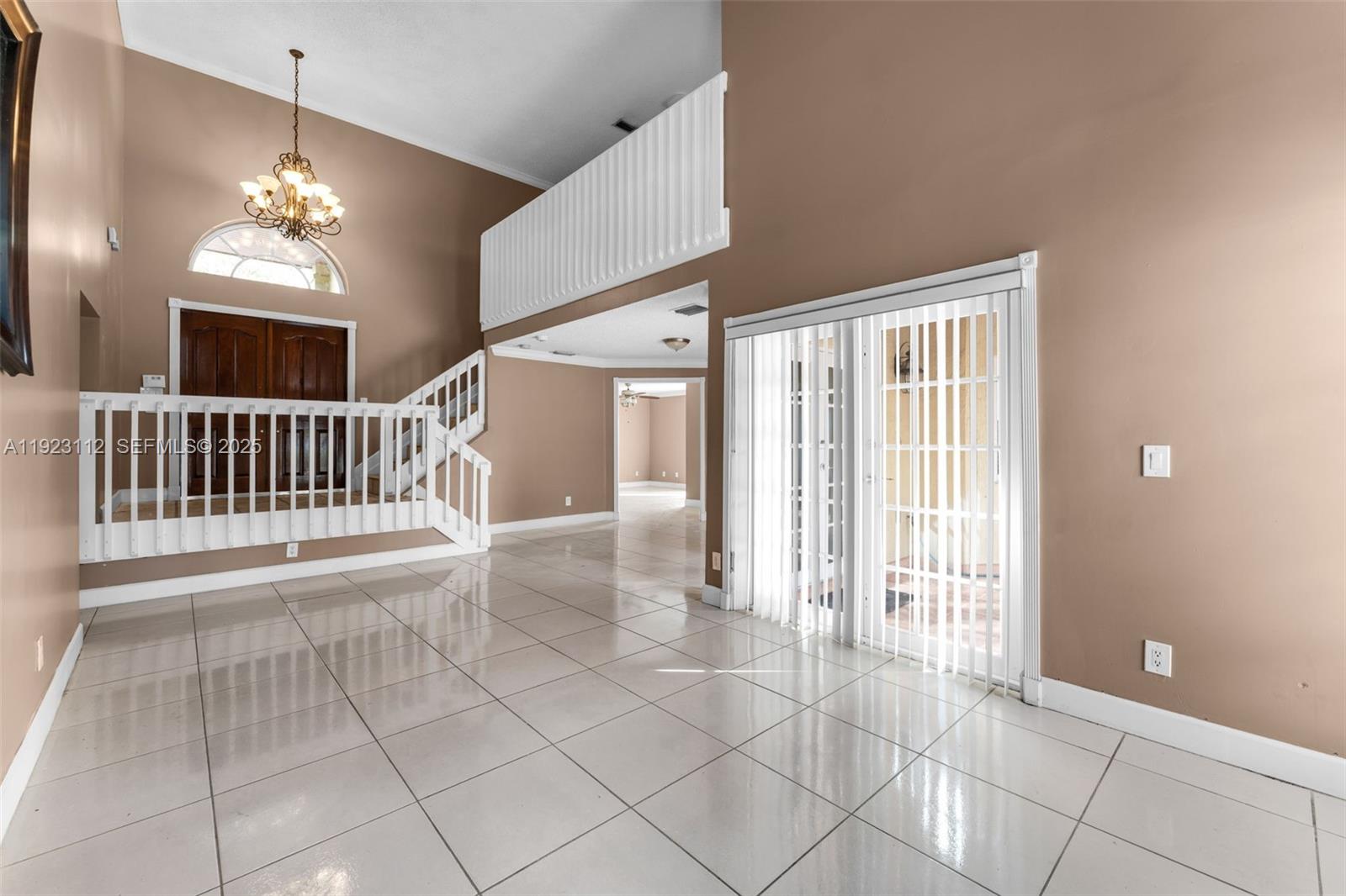 15016 Southwest 139th Avenue Miami, FL 33186 - Photo 11 of 24 a view of a livingroom with a ceiling fan windows and entryway