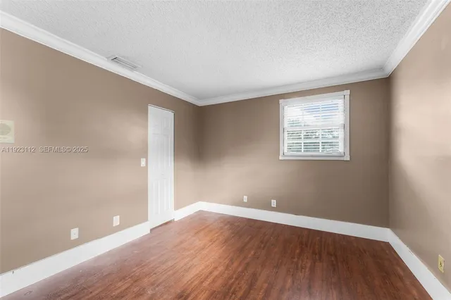 a bathroom with a granite countertop sink a mirror and shower