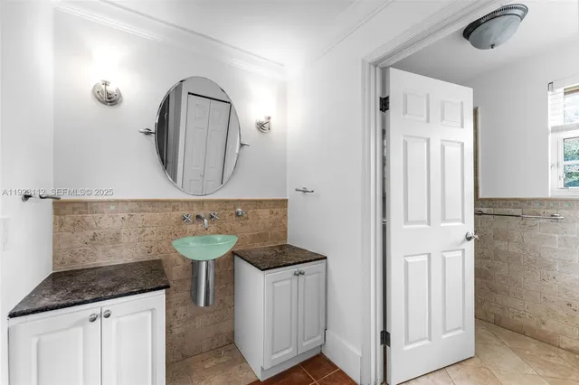 a bathroom with a toilet a sink and a window