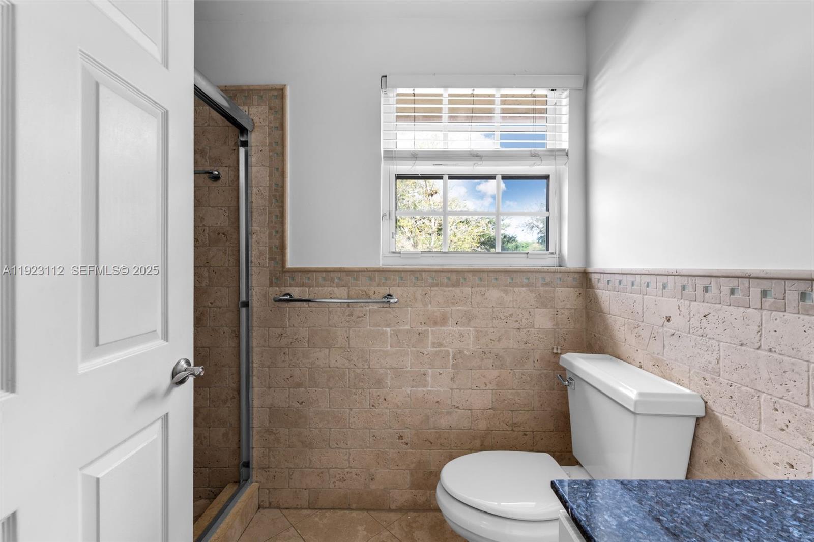 15016 Southwest 139th Avenue Miami, FL 33186 - Photo 18 of 24 a bathroom with a toilet a sink and a window