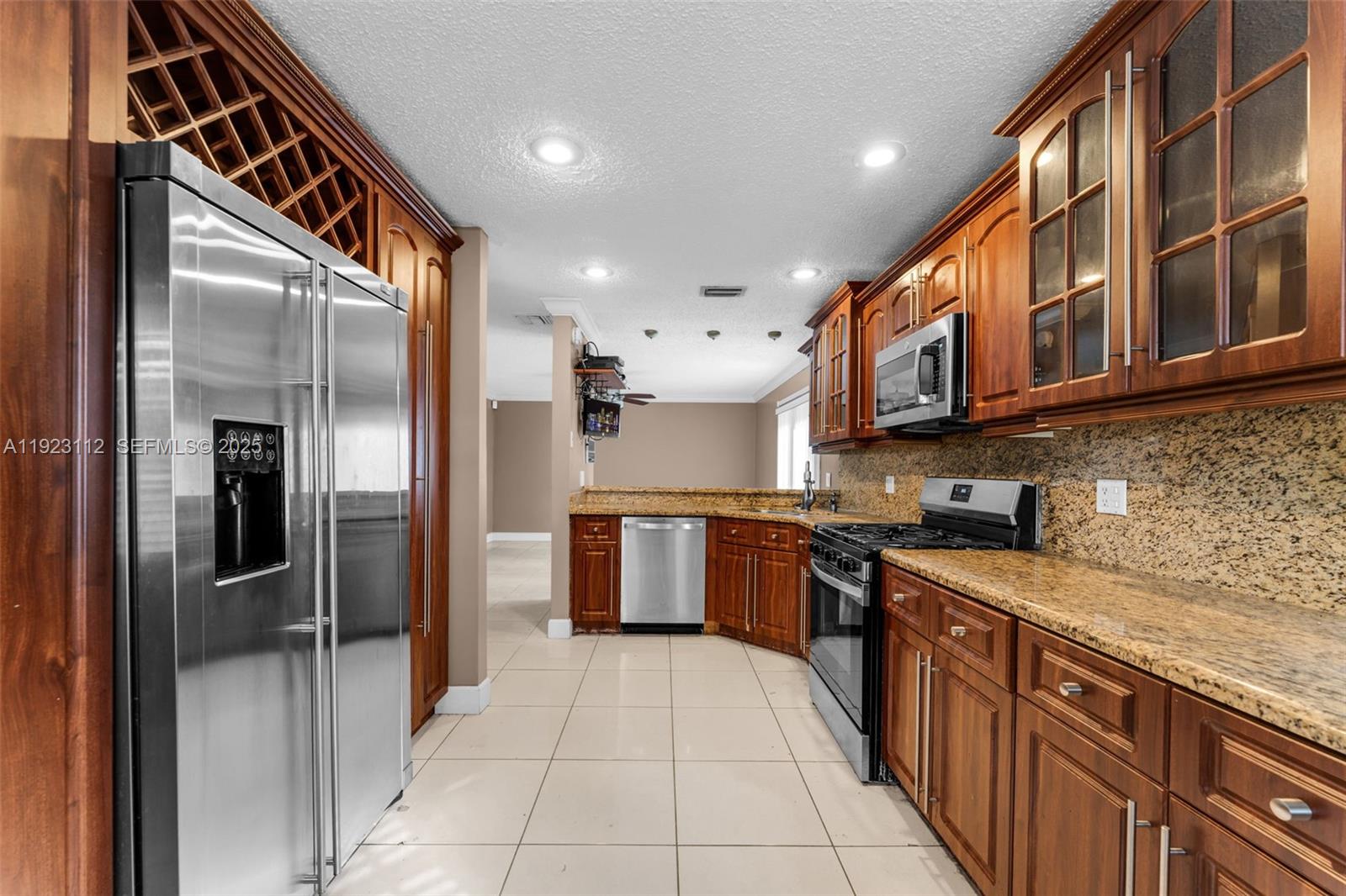 15016 Southwest 139th Avenue Miami, FL 33186 - Photo 7 of 24 a kitchen with stainless steel appliances granite countertop a refrigerator and a sink