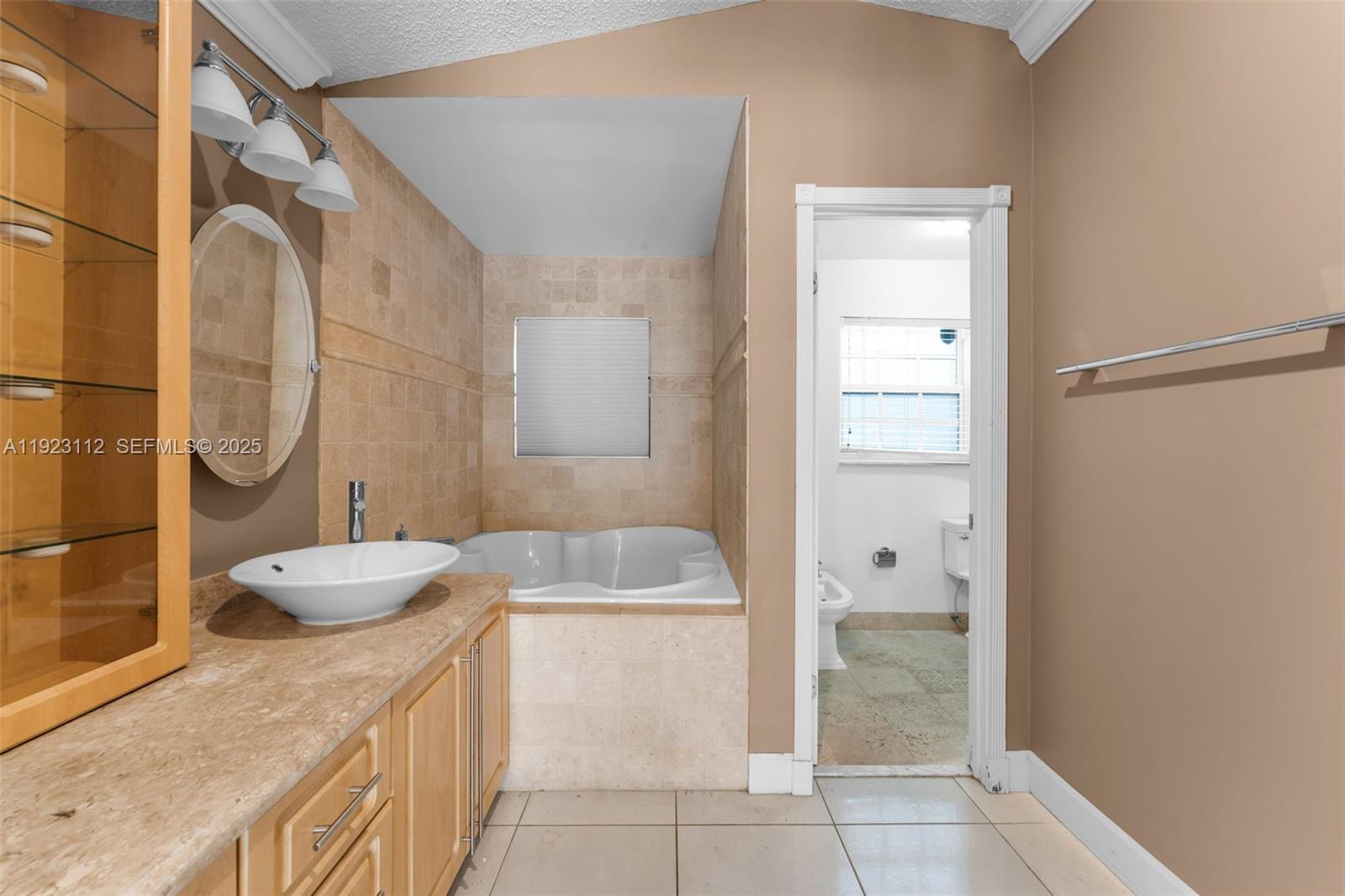 15016 Southwest 139th Avenue Miami, FL 33186 - Photo 10 of 24 a bathroom with a granite countertop sink a toilet and shower