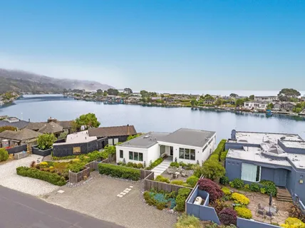 a balcony with outdoor seating and lake view