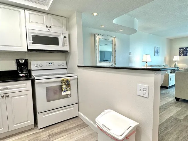 a kitchen with stainless steel appliances a stove microwave and cabinets