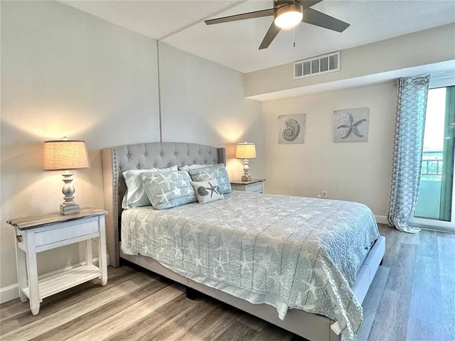 a bedroom with a bed and a lamp on the dresser