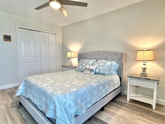 a bedroom with a bed and a lamp on table