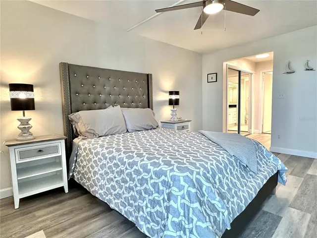 a bedroom with a bed and wooden floor