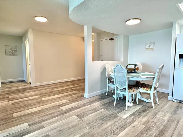 a dining room with furniture and wooden floor