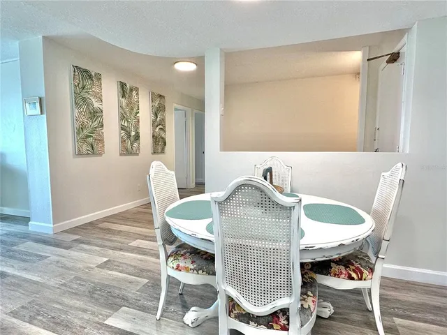 a living room with dining table and a window
