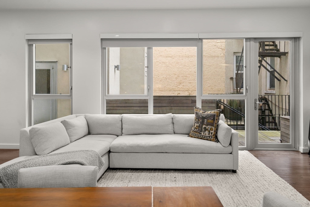 126 Salem Street, Unit 3 Boston, MA 02113 - Photo 15 of 27 a living room with furniture and a large window