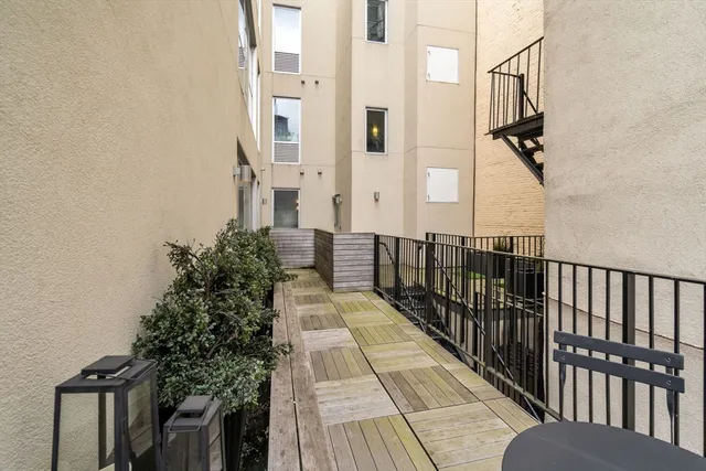a view of a balcony with wooden floor