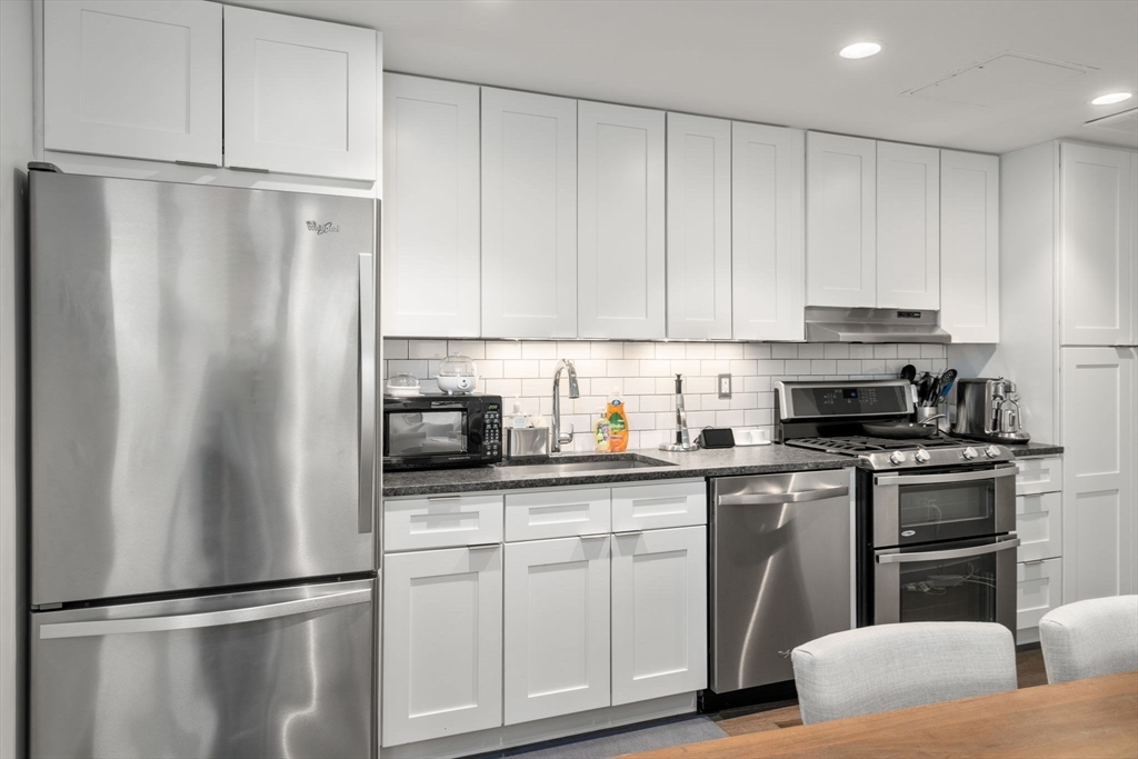 126 Salem Street, Unit 3 Boston, MA 02113 - Photo 6 of 27 a kitchen with stainless steel appliances granite countertop a refrigerator sink and cabinets