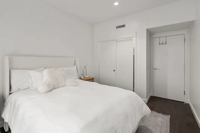 a bedroom with a bed and a night stand