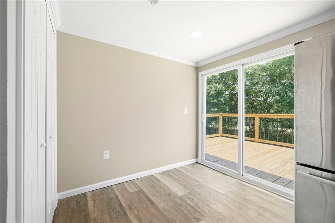 418 Old River Road Pelzer, SC 29669 - Photo 9 of 29 Sliding glass doors open to a private wooden deck, extending your living space outdoors.