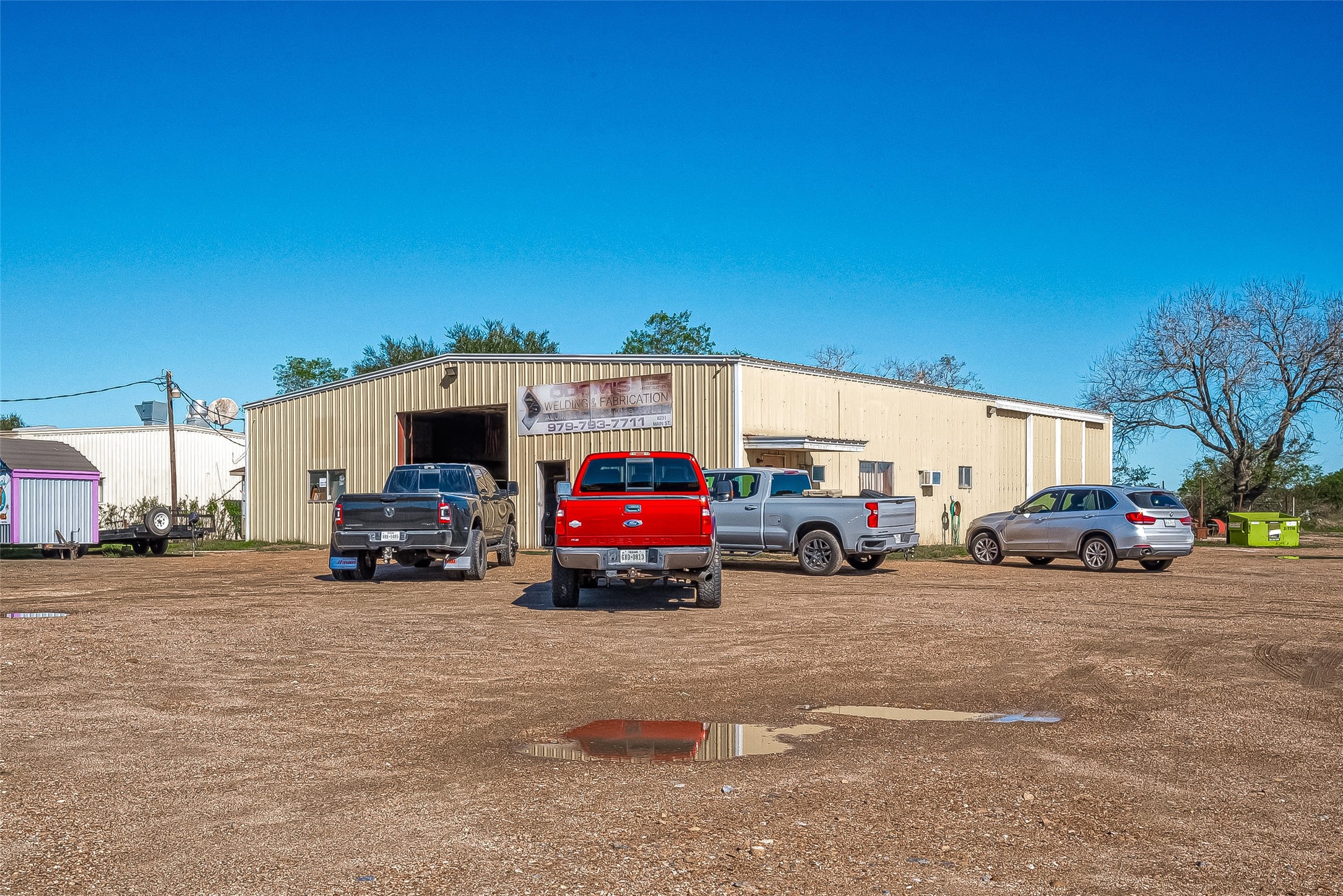 8231 Main Street Needville, TX 77461 - Photo 4 of 43 a view of a cars parked in front of a building